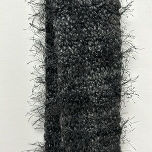 gray and black woven scarf, it is thinner than conventional